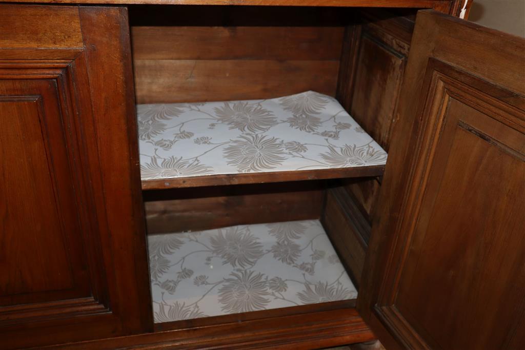 A 19th century French walnut four door panelled cupboard, width 210cm, depth 46cm, height 87cm